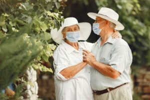 Beautiful old couple spend time in a summer garden
