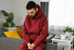 Sad man pondering about his life after a relationship breakup or bipolar disorder - depression