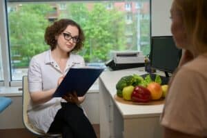 Woman nutritionist advises a client in a fitness clinic