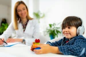 Pediatric Audiologist Testing Hearing with a Little Boy