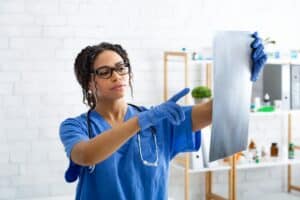 Thoughtful radiologist looking at animal xray in veterinarian hospital