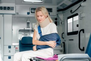 on the street in an ambulance a young patient with an injured neck and arm transporting the patient
